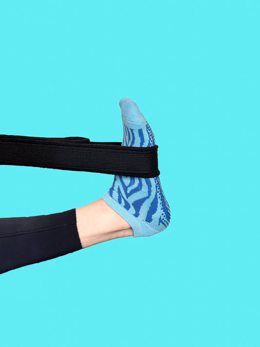 Blue pair of Flow Peppy, New Zealand made ankle pilates and yoga grip socks blue patterns.
