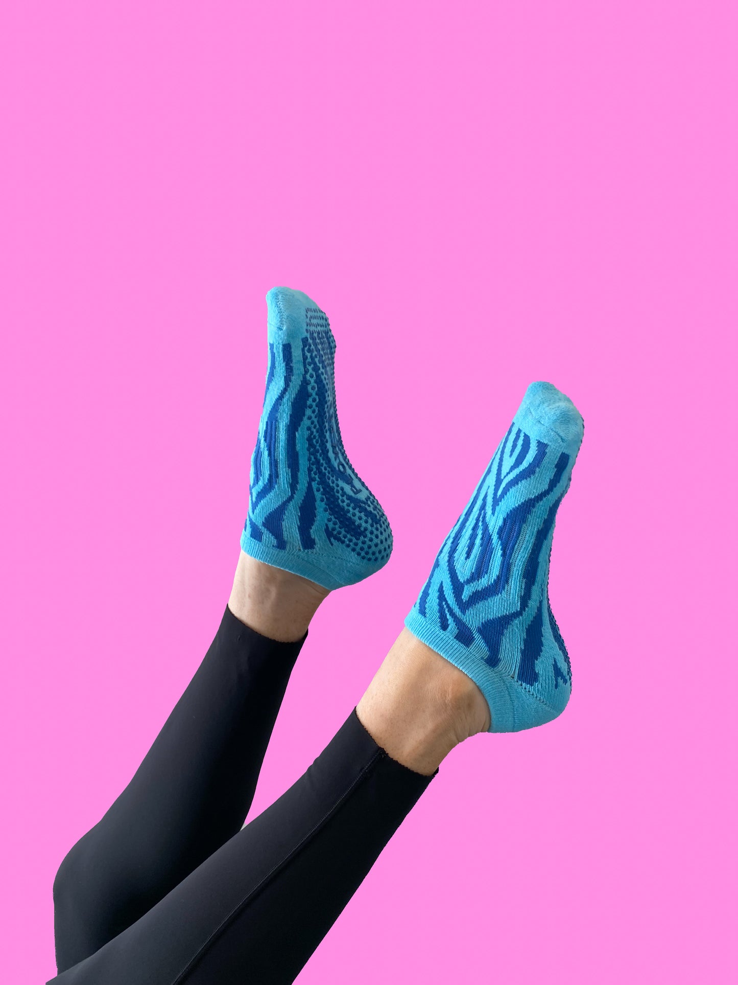 Blue pair of Flow Peppy, New Zealand made ankle pilates and yoga grip socks blue patterns.