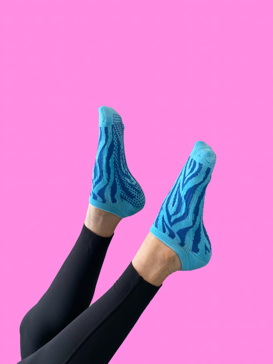 Blue pair of Flow Peppy, New Zealand made ankle pilates and yoga grip socks blue patterns.